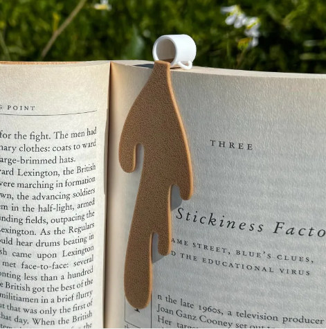 Creative Coffee Bookmark displaying a unique design, keeping place in a book against a floral background.